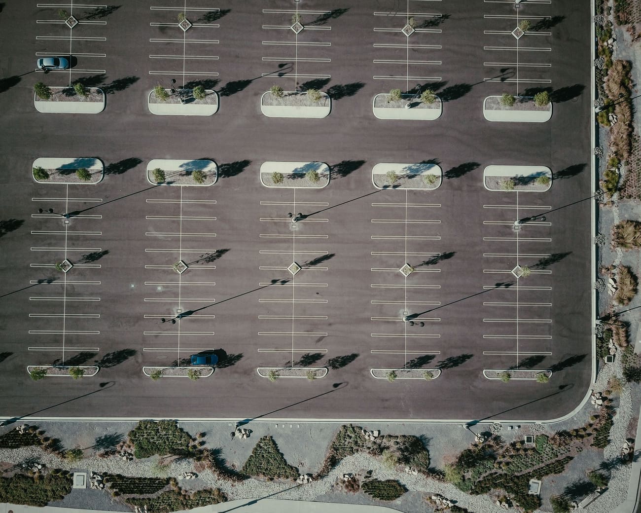 Aerial view of a large striped commercial parking lot